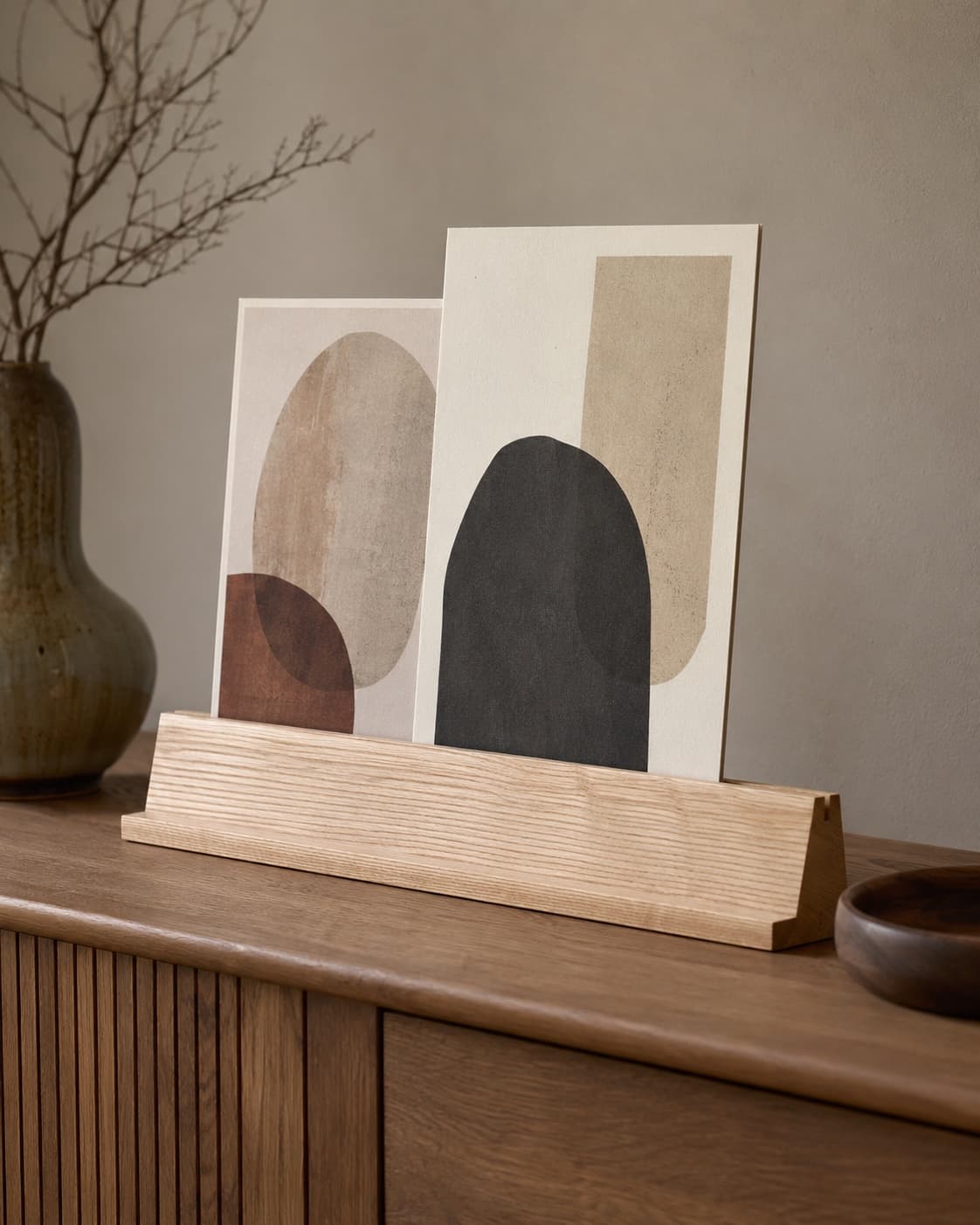 Wooden photo ledge displayed freestanding with generic unbranded prints